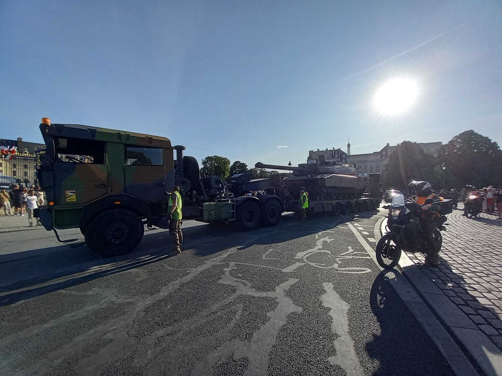 A tank on and a militar truck